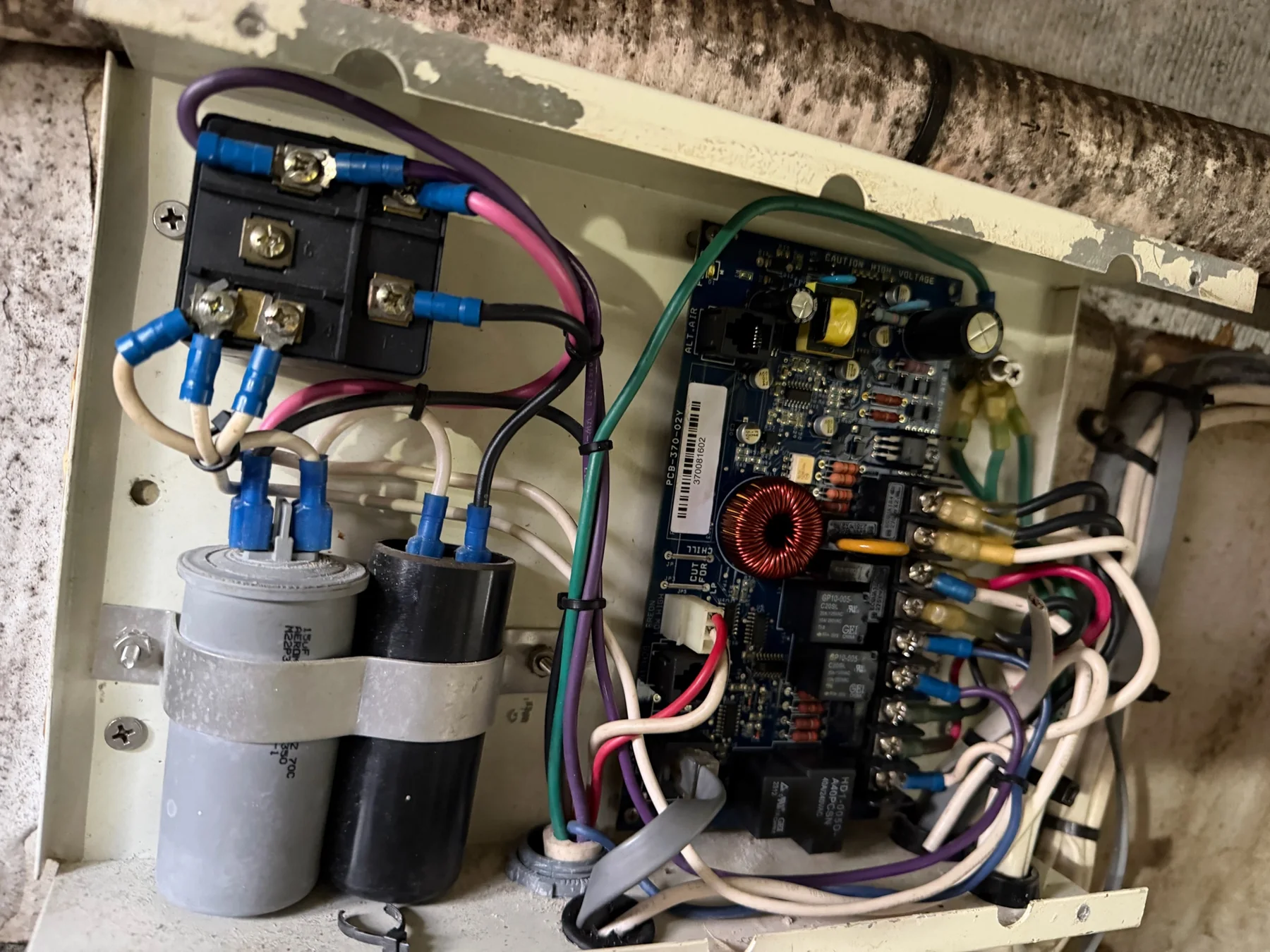Open marine HVAC control box with circuit board, relay, capacitors, and wiring