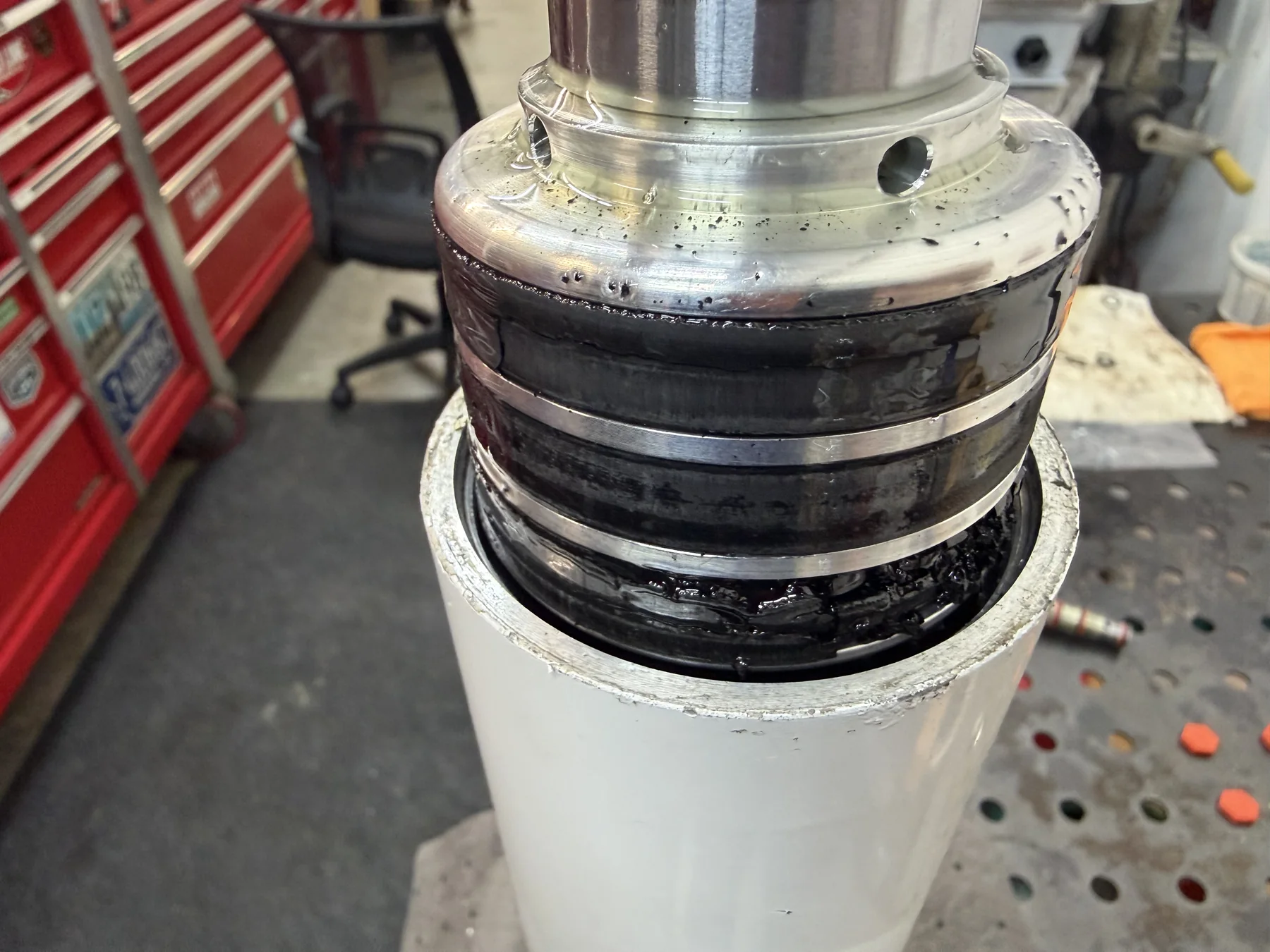 Hydraulic cylinder piston and rod assembly during workshop reassembly