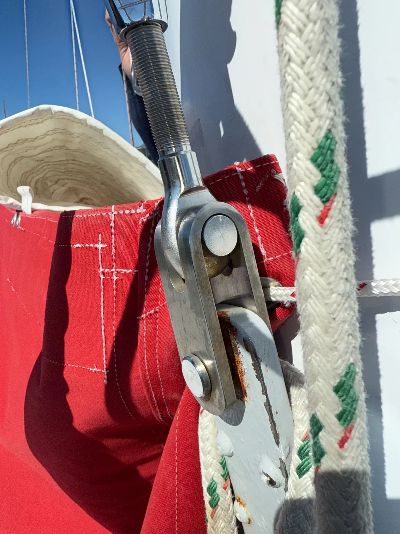 Stainless steel standing-rigging terminal pinned to a sailboat chainplate