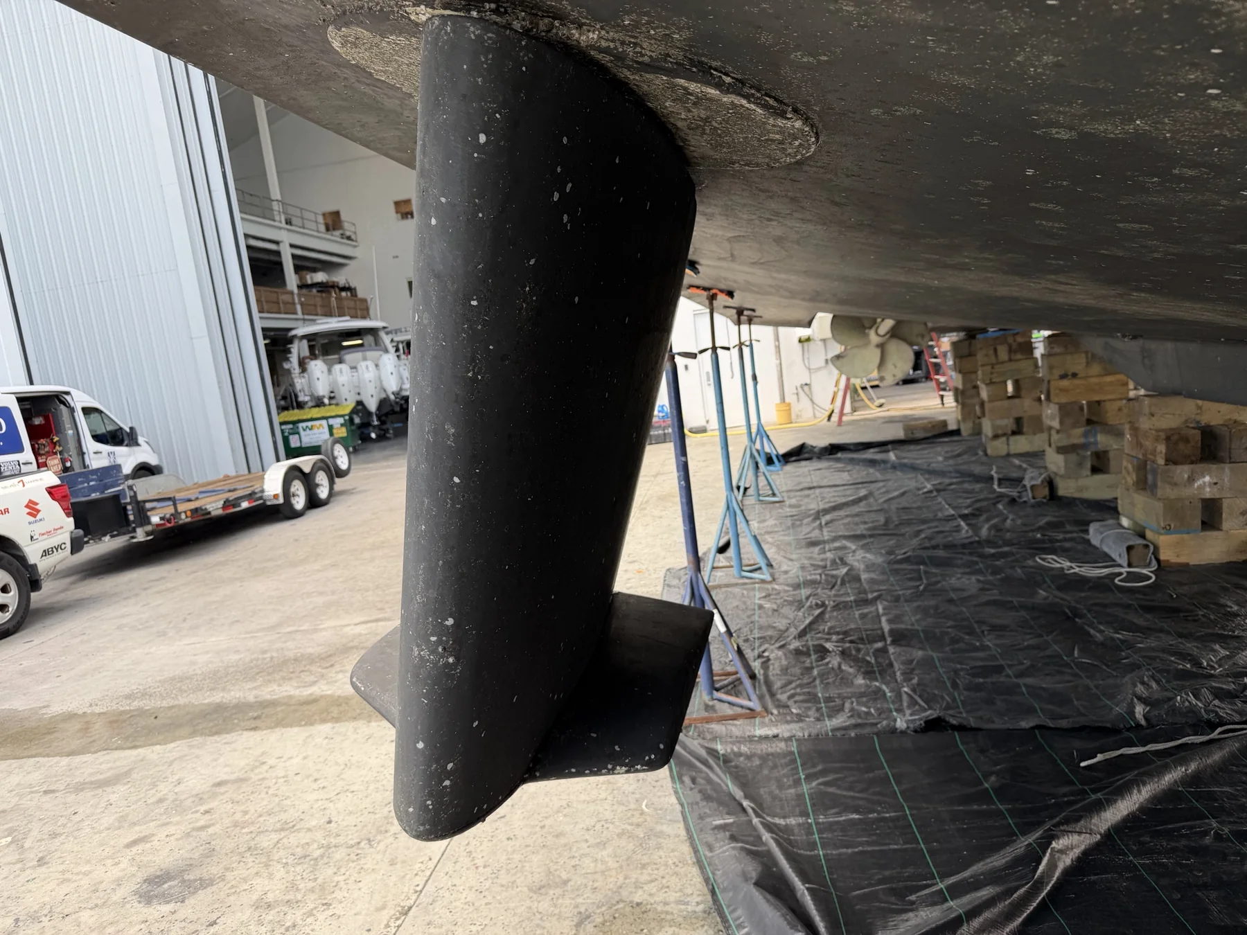 Marine stabilizer fin installed beneath a vessel hull in a boatyard