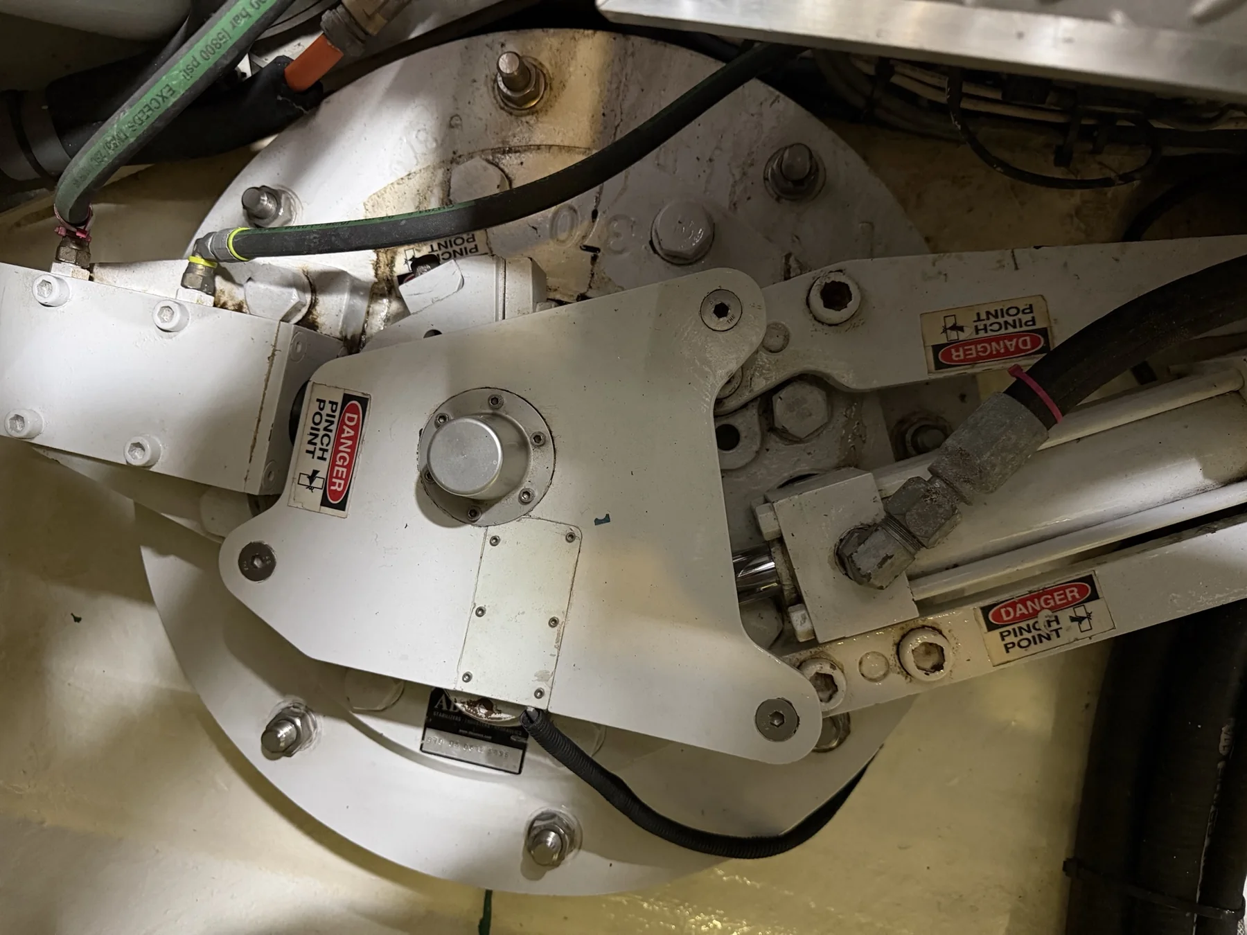 Marine stabilizer linkage, hydraulic cylinder, hoses, and pinch-point labels
